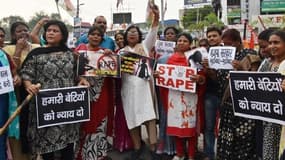 Des militantes du parti du Congrès national indien brandissent des pancartes pour protester contre l'enlèvement et le viol collectif de cinq femmes en juin 2018.