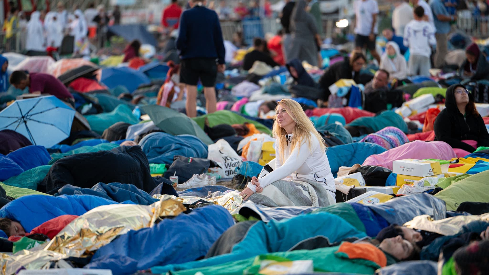 Des jeunes et des pèlerins se réveillent et se préparent à assister à la messe du pape Léon XIV à Tor Vergata à l'occasion du Jubilé de la jeunesse à Rome, Italie, le 3 août 2025.