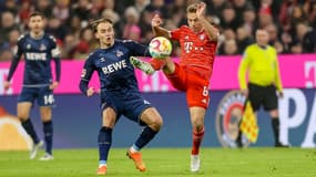 Mathias Olesen et Joshua Kimmich lors d'un match Bayern-Cologne, à Munich le 24 janvier 2023