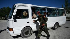 Un soldat afghan escorte un bus transportant des prisonniers talibans libérés de la prison de Bagram, le 26 mai 2020.