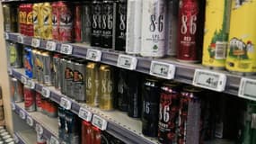 Illustration de bières en canettes en vente au sein d'un supermarche Carrefour à Paris le 23 avril 2024. 