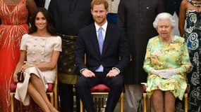 La reine Elizabeth II, le prince Harry et son épouse Meghan en juin 2018 à Buckingham, à Londres