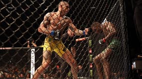 Alex Pereira (à gauche) frappe Israel Adesanya avant l'arrêt de leur combat au cinquième round à l'UFC 281