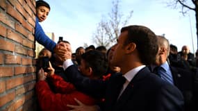 Emmanuel Macron serrant la main d'un jeune garçon, à Amiens le 22 novembre 2019