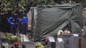 Des gendarmes français montent la garde alors qu'une bâche recouvre la pierre tombale vandalisée du défunt leader d'extrême droite Jean-Marie Le Pen, à La Trinité-sur-Mer, dans l'ouest de la France, le 31 janvier 2025.