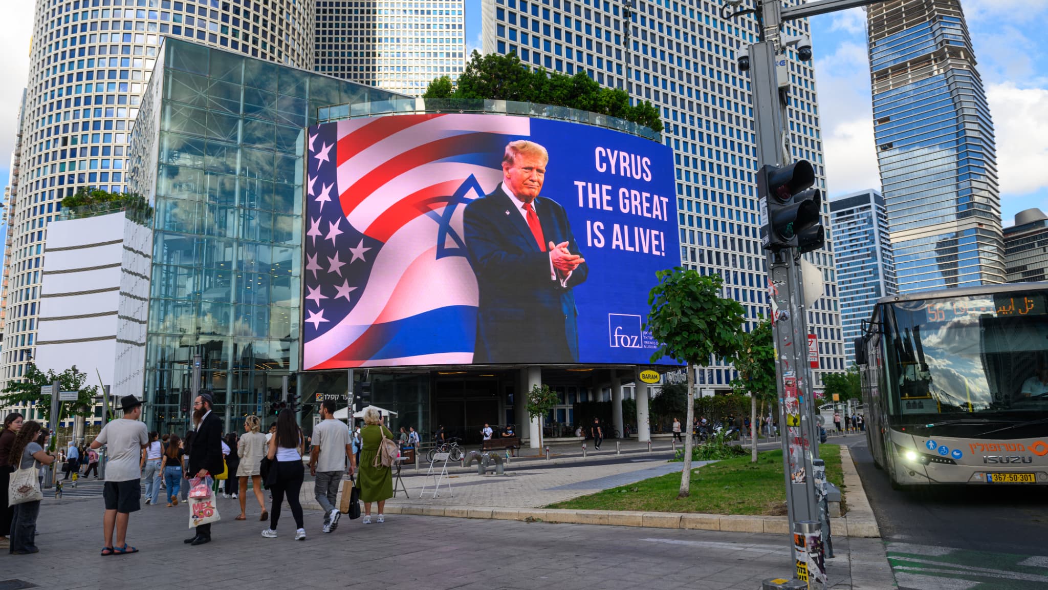 A sign featuring US President Donald Trump is seen near the Azrielli Towers on October 12, 2025 in Tel Aviv, Israel.