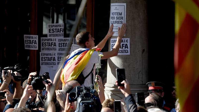 Un manifestant pro-indépendance colle des affiches pendant une démonstration de force des partisans du "oui", le 20 septembre, à Barcelone.