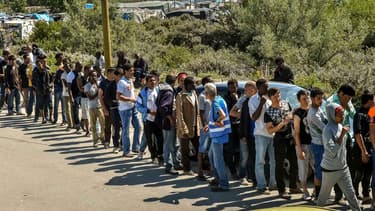 Migrants faisant la queue pour recevoir la nourriture d'une organisation humanitaire, le 8 août 2015