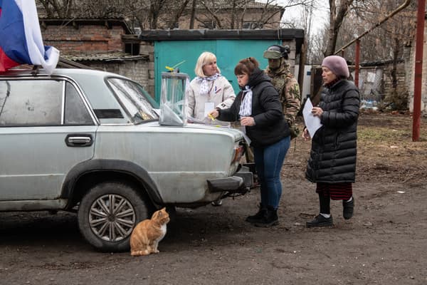 Des femmes devant un bureau de vote mobile lors du scrutin de l'élection présidentielle russe à Donetsk, en Ukraine contrôlée par la Russie, le 14 mars 2024.
