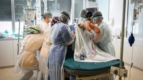 Des membres du personnel médical se tiennent autour d'un patient infecté par le Covid-19 à l'unité de soins intensifs de l'hôpital intercommunal André-Grégoire, à Montreuil, le 1er avril 2021