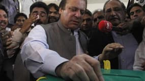 L'ancien Premier ministre Nawaz Sharif, ici dans un bureau de vote de Lahore, a revendiqué la victoire de son parti la Ligue musulmane (PML-N, opposition) aux élections législatives de samedi au Pakistan. /Photo prise le 11 mai 2013/REUTERS/Mohsin Raza