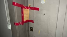Un scellé condamne la porte d'un appartement situé au 5 quai Perrache à Lyon, là où le corps d’un homme de 54 ans a été retrouvé, mutilé, dimanche matin. 