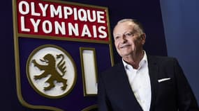 Jean-Michel Aulas posant devant le logo du club pour célébrer les 30 ans de sa présidence, en 2017