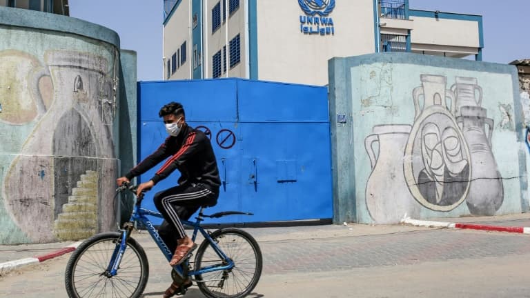 Un palestinien circule en vélo devant les portes fermées d'une école gérée par l'Agence de l'ONU pour les réfugiés palestiniens (Unrwa) à Rafah, le 6 avril 2021