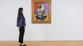 Une femme devant le tableau "Femme accroupie en costume turc (Jacqueline)" de Picasso