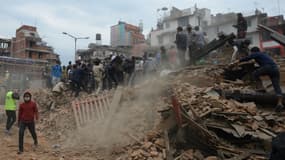 Des hommes évacuent les décombres à Katmandou, après le violent séisme qui a frappé le Népal samedi 25 avril 2015.