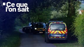 Des véhicules de gendarmerie garées près des lieux de la fusillade à Espinasse-Vozelle (Allier).