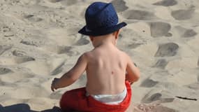 Image d'illustration - Bébé sur une plage couvert d'un chapeau