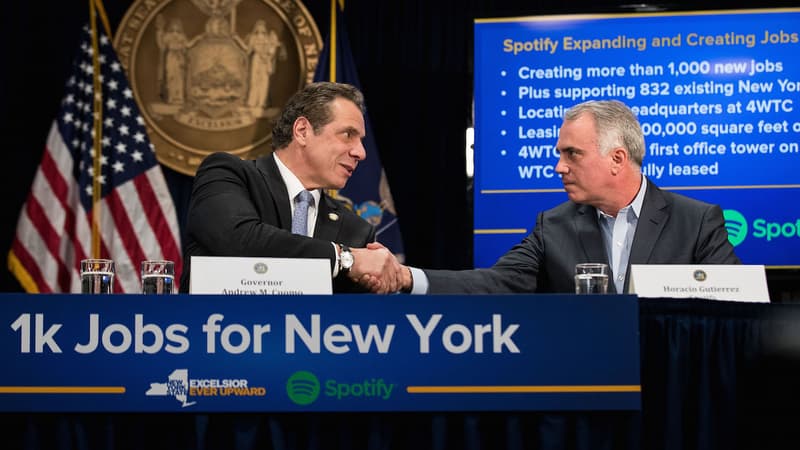 Une poignée de main de 11 millions de dollars entre Andrew Cuomo, gouverneur de l'état de New York, et Horacio Gutierez, General Counsel de Spotify.