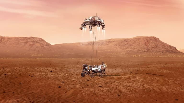 Illustration fournie par la Nasa du rover Perseverance au moment de son atterrissage sur Mars, après avoir descendu les derniers mètres le séparant du sol le long de câbles suspendus depuis l'étage de descente 