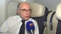 Bernard Cazeneuve s'exprime au micro de BFMTV, dans l'avion l'emmenant à Washington, le 19 février. 