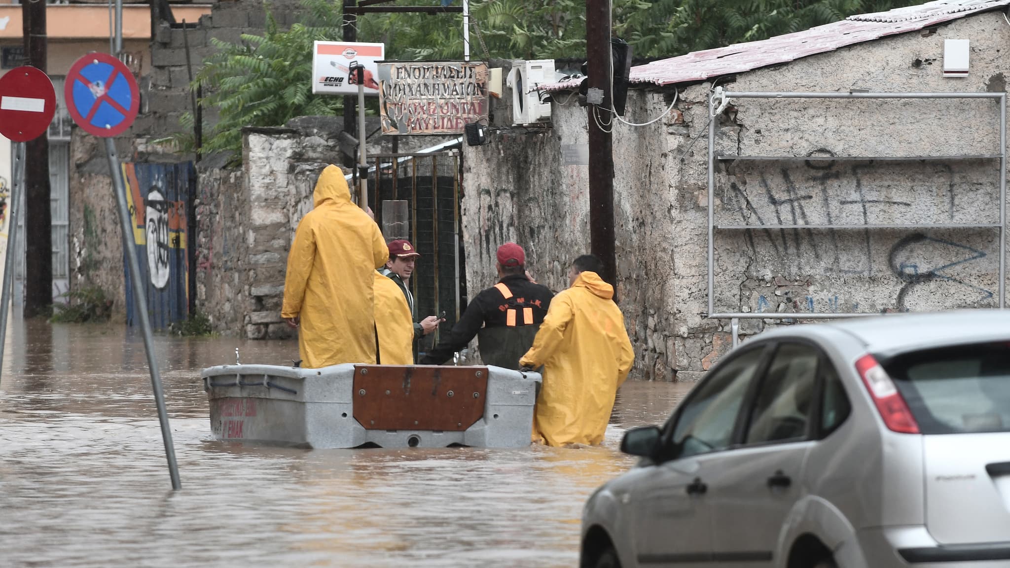 Des pompiers et des membres de la sécurité civile se tiennent dans une rue inondée de la ville de Volos, dans le centre de la Grèce, le 6 septembre 2023.