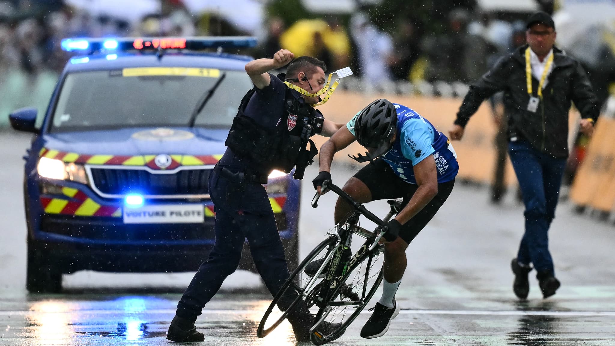 Un CRS intercepte un cycliste amateur tentant de franchir la ligne d'arrivée du Tour de France à Valence le 23 juillet 2024 Un CRS intercepte un cycliste amateur tentant de franchir la ligne d'arrivée du Tour de France à Valence le 23 juillet 2024