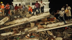 Les secours et les habitants recherchant des survivants, suite à l'effrondrement d'un immeuble en construction, dans la banlieue de Bombay.