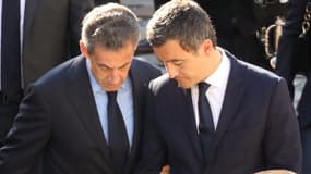 L'ancien président de la République Nicolas Sarkozy (à gauche) au bras de Gérald Darmanin (à droite), alors ministre de l'Action et des Comptes publics, lors de l'hommage national à Charles Aznavour le 5 octobre 2018 à Paris.