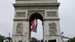 Le président Emmanuel Macron dépose une gerbe de fleurs sur la tombe du soldat inconnu à l'Arc de Triomphe, à Paris le 8 mai 2022. 
