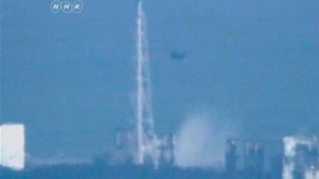 Un hélicoptère jette de l'eau sur les réacteurs de la centrale Fukushima. Les autorités japonaises ont poursuivi jeudi, avec à peine plus de succès que la veille, leurs tentatives de refroidissement de la centrale nucléaire de Fukushima, sous l'oeil de pl