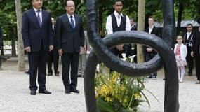 François Hollande aux côtés du président du Sénat Jean-Pierre Bel (à gauche) lors d'une cérémonie de commémoration de l'esclavage vendredi dans les jardins du Luxembourg. François Hollande a souligné "l'impossible réparation" des ravages de l'esclavage, "