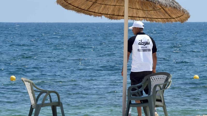 Un membre de la police du tourisme tunisienne surveille les vacanciers lors d'un hommage aux victimes de Sousse