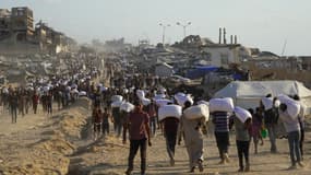 Des Palestiniens, en proie à la famine, recevant de la farine lors d'une distribution d'aide humanitaire à Gaza le 31 juillet 2025 (image d'illustration)