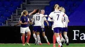 La joie de l'attaquante américaine Megan Rapinoe, félicité par ses coéquipières, après avoir ouvert le score sur pénalty face à la France, lors de leur match amical, le 13 avril 2021 au stade Océane au Havre