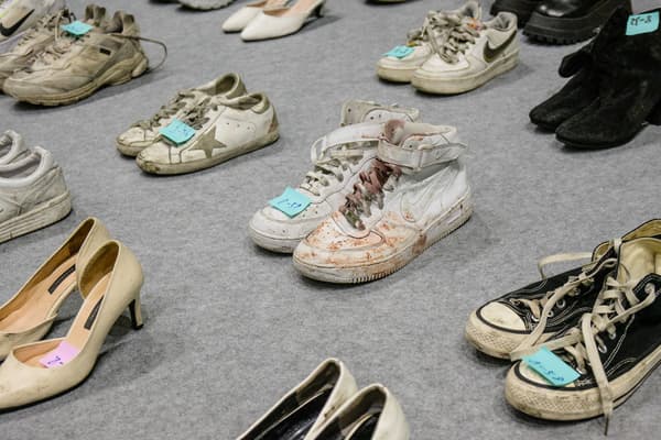 Dozens of pairs of shoes were collected by Seoul authorities.  Some, like this pair of white sneakers, are stained with blood.