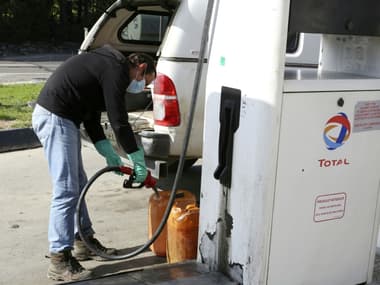 Un conducteur remplit des bidons d'essence le 14 février 2022 à Lucciana, en Corse.