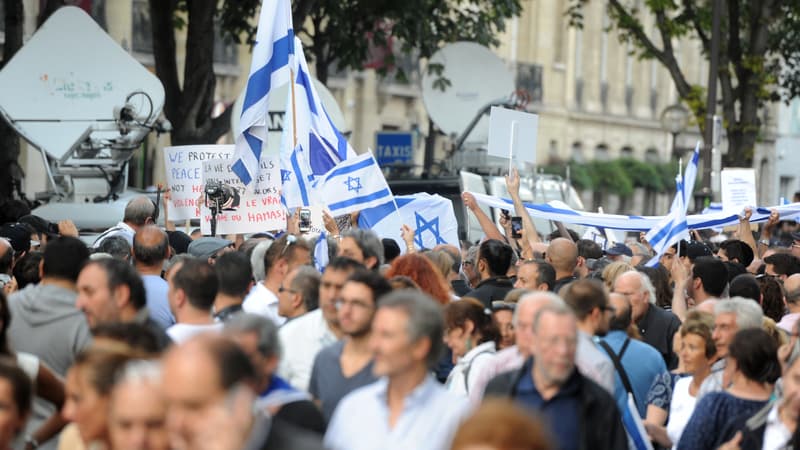 Des personnes tiennent des panneaux dénonçant le terrorisme et agitent des drapeaux nationaux israéliens lors d'une manifestation pro-israélienne appelée par le Conseil représentatif des institutions juives de France (CRIF) devant l'ambassade de l'État juif, le 31 juillet 2014 à Paris. Photo d'illustration 