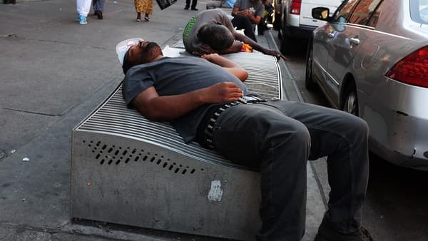 Des hommes dorment dans la rue à Harlem (New York), le 5 août 2015 après des prises de cannabis synthétiques qui induisent un effet zombie