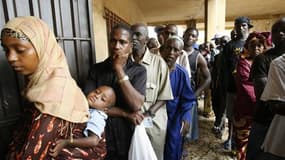 Devant un bureau de vote, mis en place dans une école de Conakry. Entre 75 et 80% des Guinéens ont voté dimanche pour le premier scrutin présidentiel libre et démocratique organisé dans ce pays, la première colonie française d'Afrique de l'Ouest à accéder