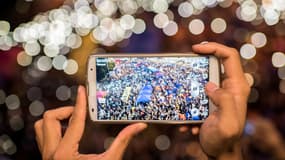 Un manifestant pro-démocratie prend la foule en photo à Hong Kong en octobre 2014