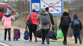 Des réfugiés ukrainiens traversent à pied la frontière avec la Hongrie, le 28 février 2022