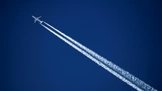Un avion commercial de la compagnie aérienne allemande Lufthansa laisse une traînée de condensation dans le ciel, le 3 avril 2017, au-dessus de la station des Alpes suisses de Verbier