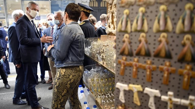 Bruno Le Maire dans une boutique de souvenirs près du sanctuaire de Notre-Dame de Lourdes, le 10 août 2020, lors de sa visite pour soutenir les professionnels du secteur du tourisme
