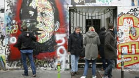 Des personnes se rendent en 2016 devant l'entrée du 5 bis rue Verneuil à Paris, maison de  Serge Gainsbourg, lors du 25e anniversaire de sa mort