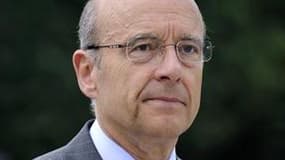 Alain Juppé a déclaré mercredi qu'il se présenterait à l'élection présidentielle de 2012 en France si Nicolas Sarkozy n'était pas candidat. /Photo prise le 10 mai 2011/REUTERS/Eric Feferberg/Pool