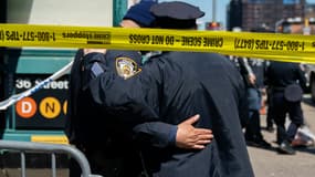 Policiers devant l'entrée de la bouche de métro où la fusillade a eu lieu, à New York, le 12 avril 2022