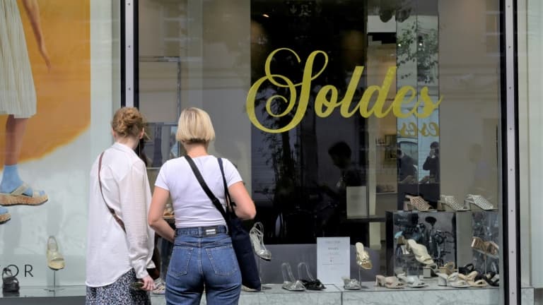 Deux femmes devant la vitrine d'un magasin de chaussures pendant les soldes, le 24 juin 2022 à Paris