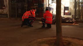 Des bénévoles de la protection civile discutant avec une personnes sans-abri lors d'une maraude dans le 14e arrondissement de Paris le soir du 9 décembre 2025.