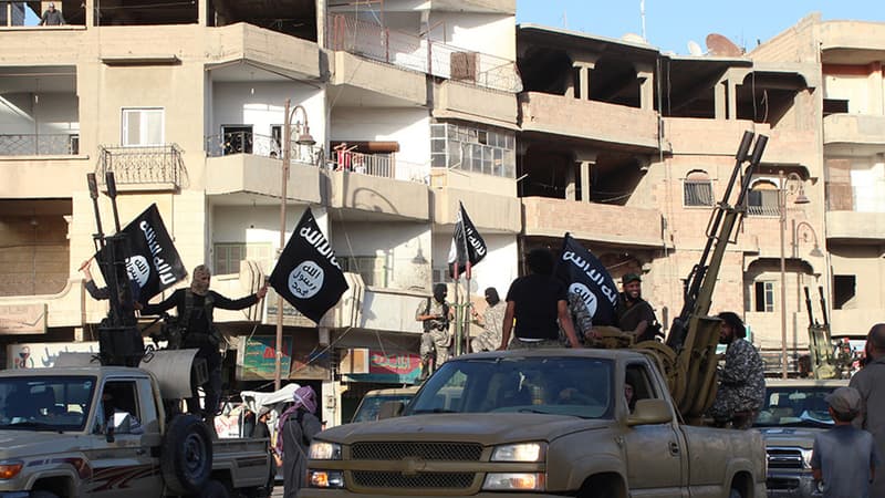 Des jihadistes de l'organisation Etat Islamique paradent dans les rues de Raqqa.